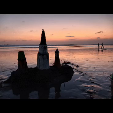 Sand constructions, changing light and people at the shoreline.