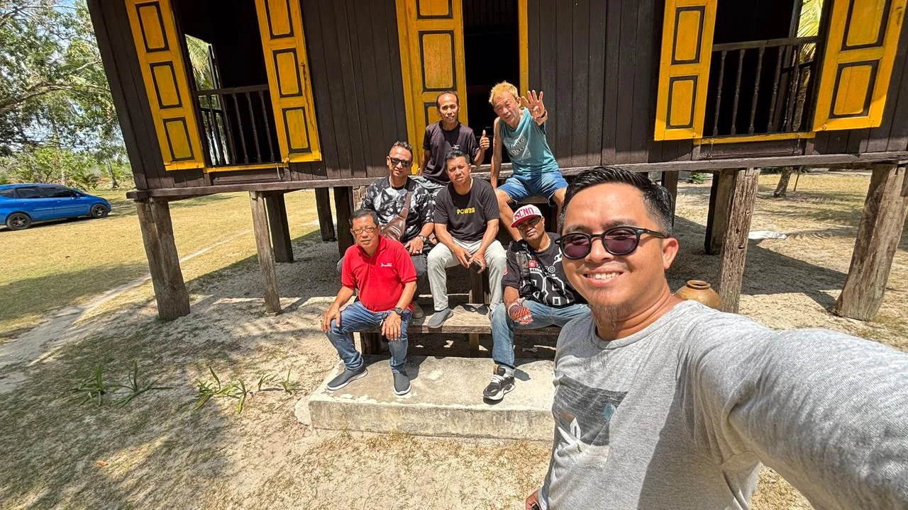 A group on the steps of a wooden house